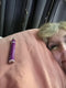 Person lying down with a purple sleep spray on their chest