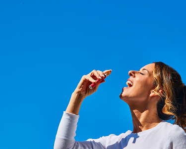 woman using rejuvia stress spray in blue sky
=